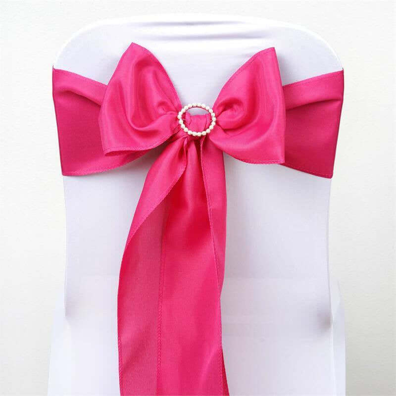 Pink satin chair sash with a pearl-accented bow. #whtbkgd