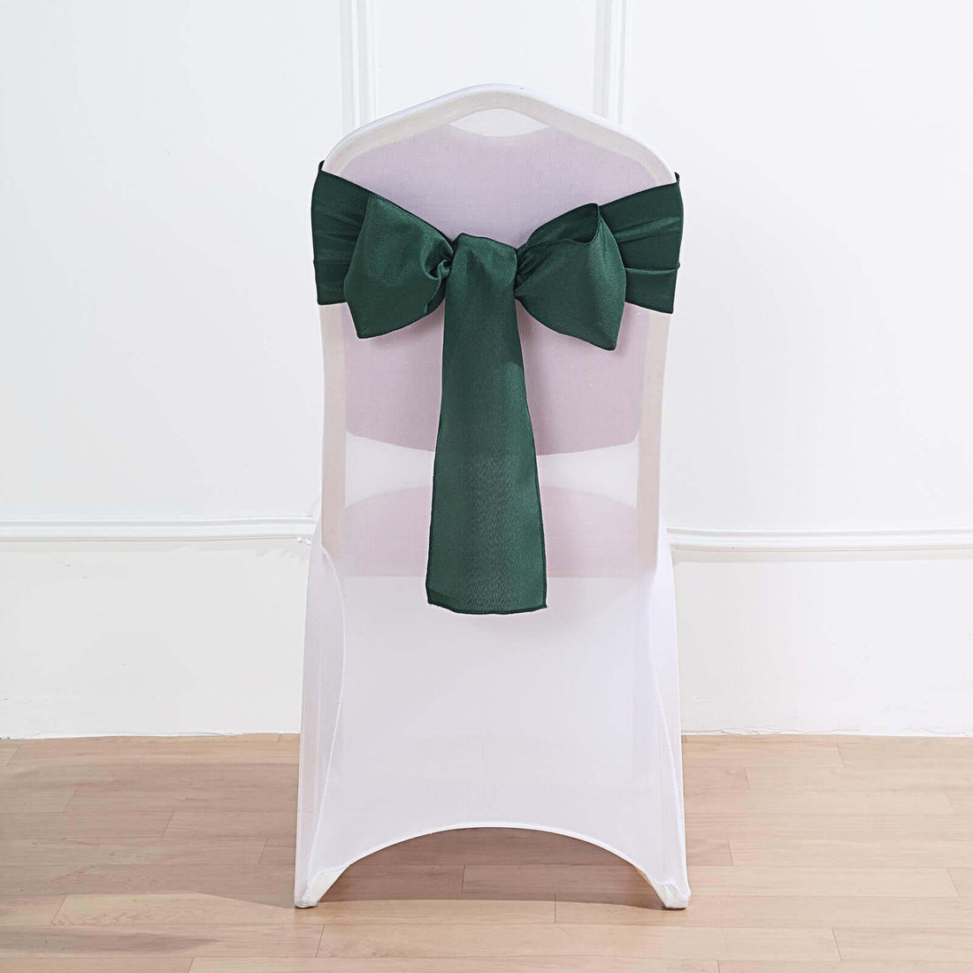Green chair sash tied elegantly on a white chair.