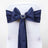 Navy blue chair sash with pearl embellishment tied in a bow. #whtbkgd