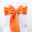 Orange satin chair sash with pearl accent bow 