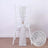 Silver chair sash with textured design draped over a white chair.