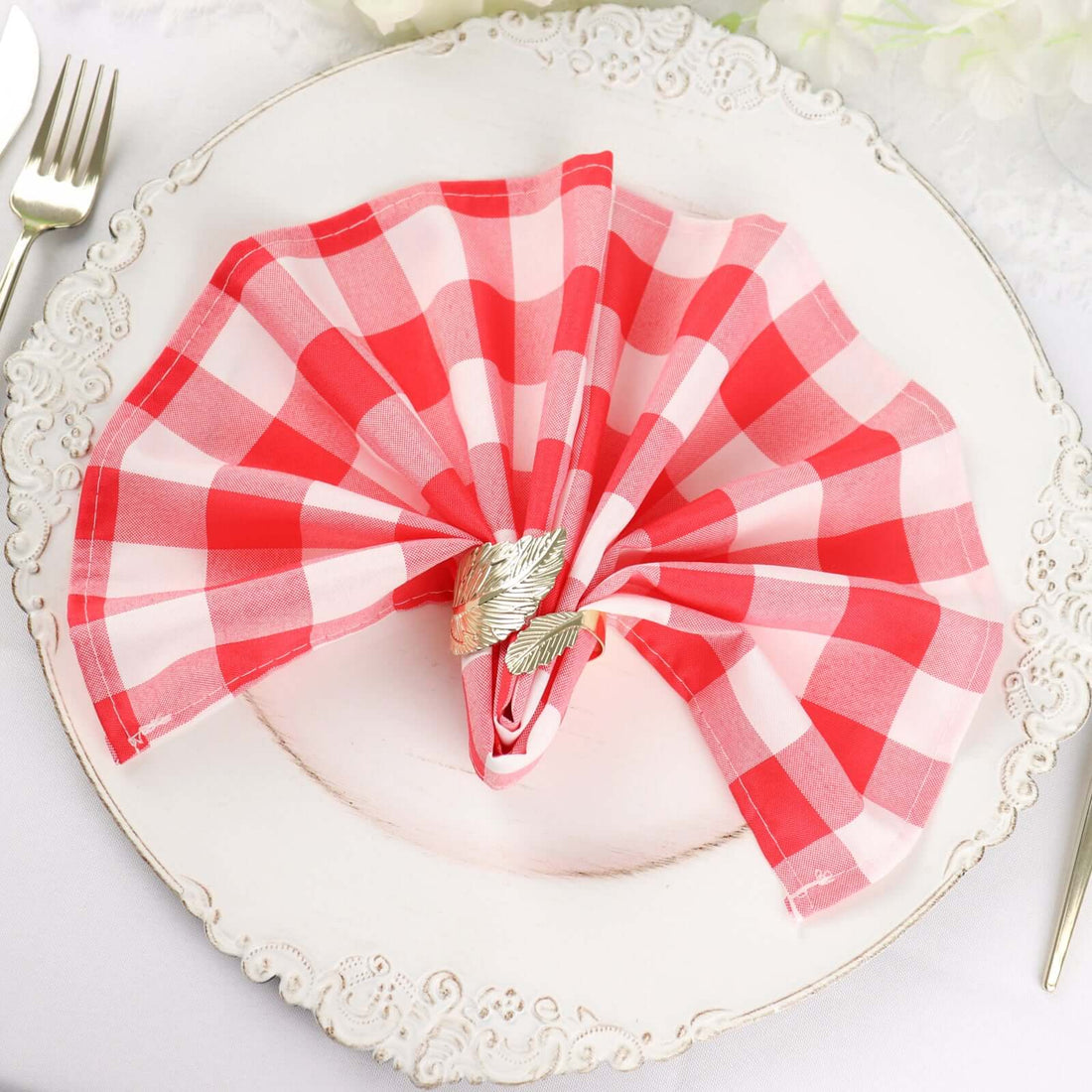Red and white checkered napkin elegantly arranged on a decorative plate.