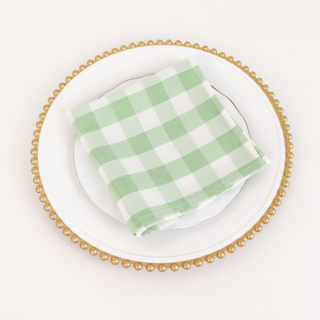 Green and white checkered napkin on a decorative plate