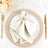 Elegant table setting with a satin napkin and decorative ring.