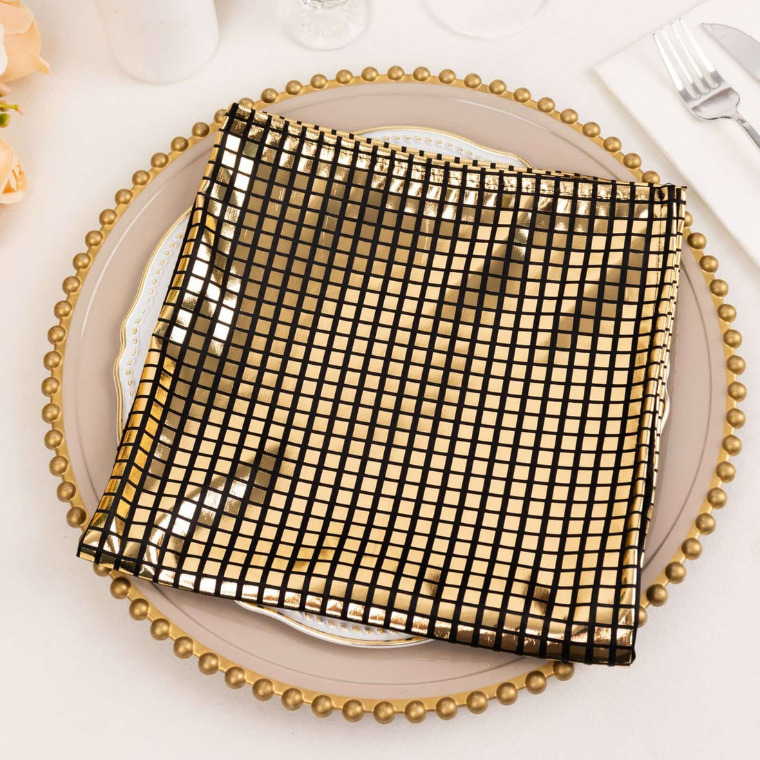 Black grid-patterned placemat on a decorative gold-rimmed plate.