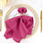 Elegant magenta napkin with butterfly holder on a decorative plate.