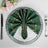 Elegant green napkin styled with gold accents on a decorative plate.