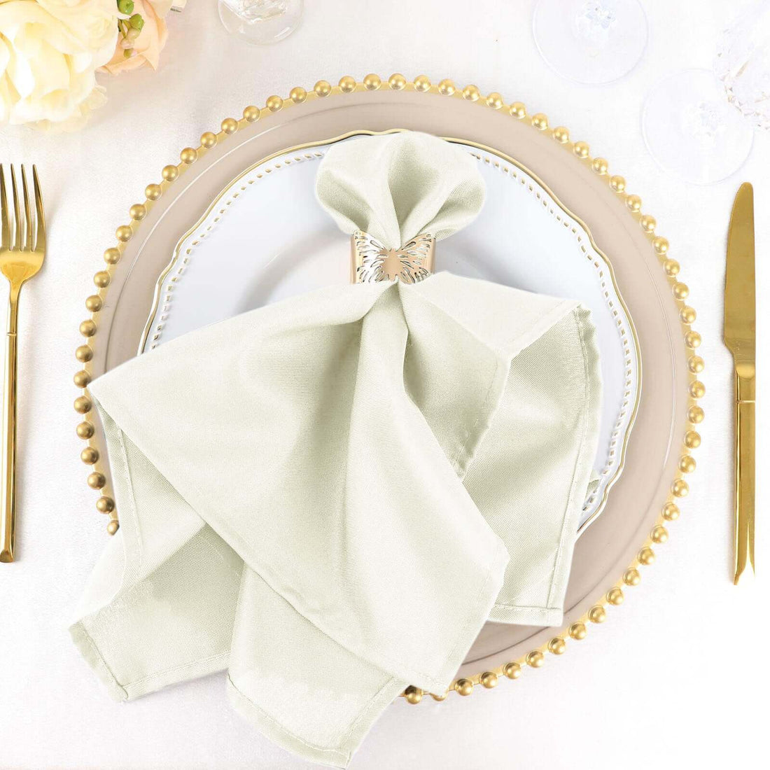 Elegant light green napkin elegantly arranged on a decorative plate.