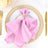 Pink napkin elegantly styled on a decorative plate with gold accents.