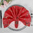 Red decorative napkin with gold accents on a styled plate setting.
