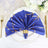 Elegant blue napkin with gold stripes, elegantly arranged on a decorative plate.