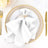 Elegant white napkin on a decorative plate with gold accents.