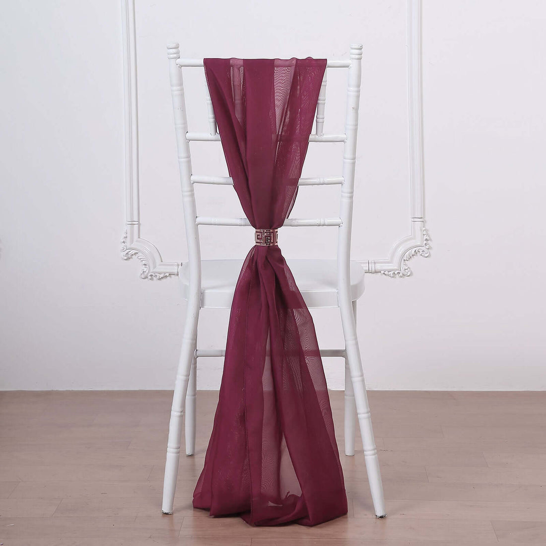Burgundy chair sash draped elegantly on a white chiavari chair