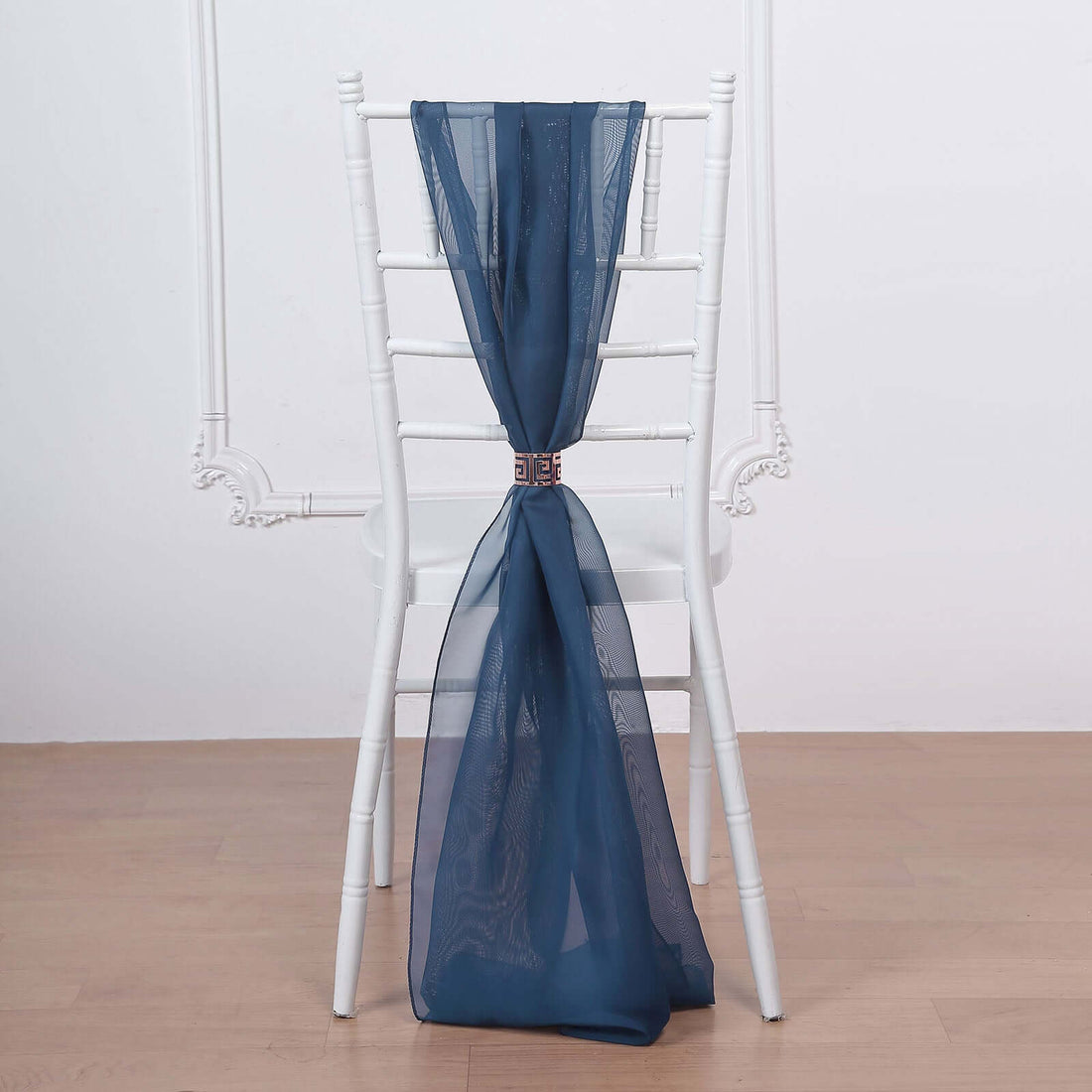Navy sheer curtain draped elegantly over a white chair