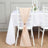 Peach chair sash draped elegantly on a white chiavari chair at a dining table.