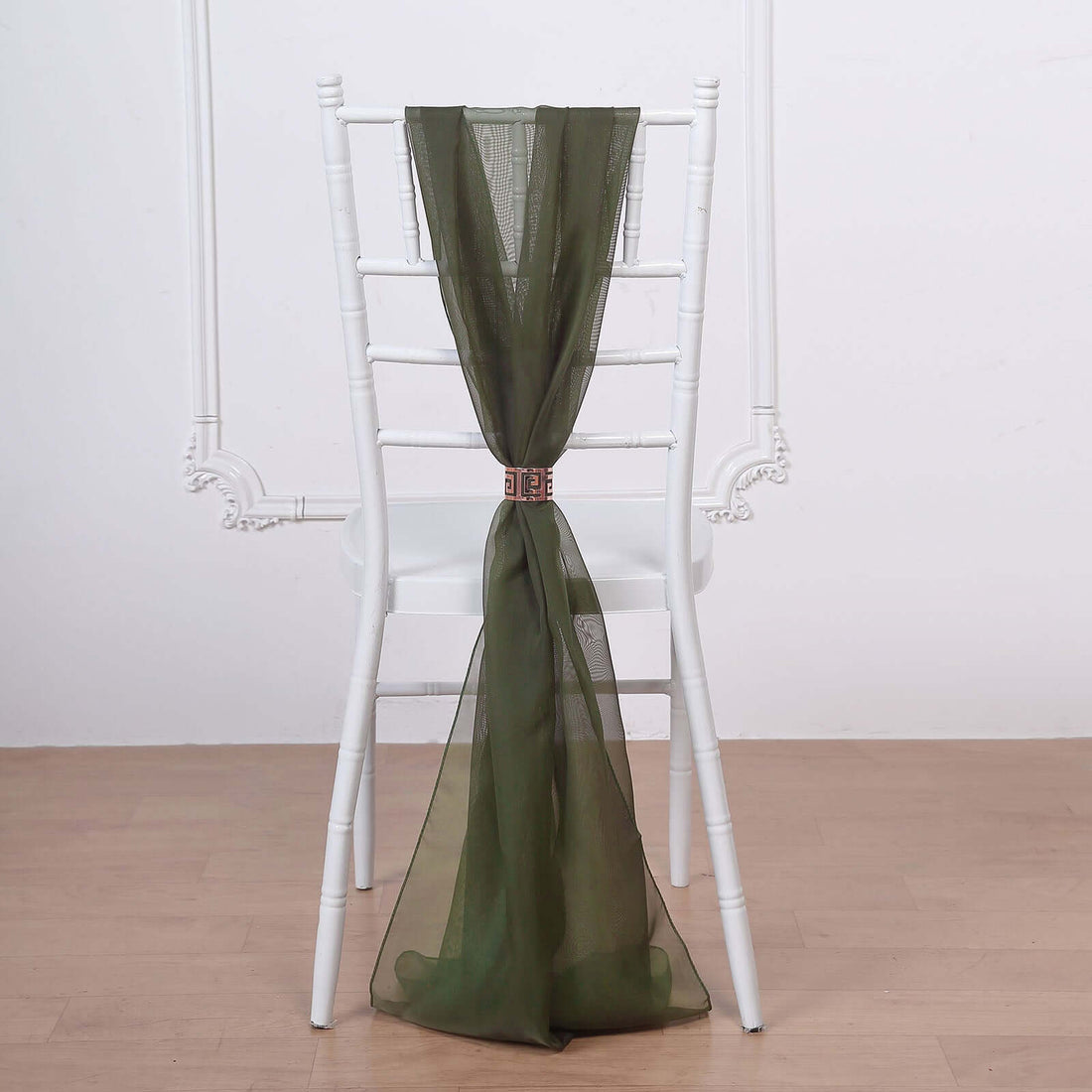 Olive green sheer chair sash tied on a white wooden chair