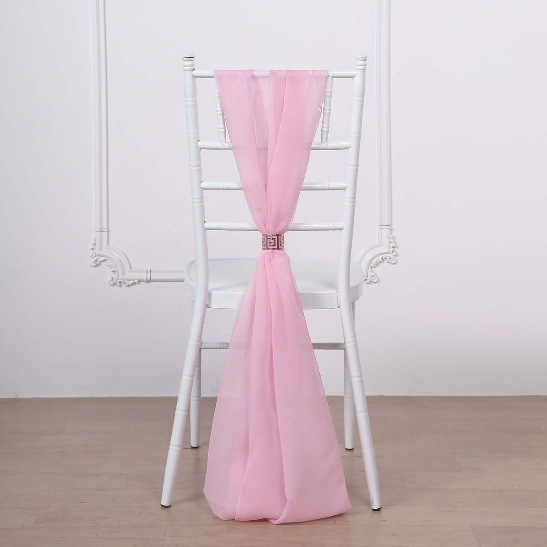 Pink chair sash draped elegantly on a white chiavari chair