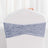 Gray velvet chair cover with gathered design on a white chair.