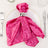 Pink velvet napkin elegantly styled on a plate with a silver napkin ring.
