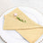 Elegant yellow napkin with a flower on a decorative plate.