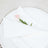 White napkin elegantly folded with a pink flower on a white plate.