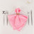 Pink napkin elegantly folded on a plate with silver cutlery arranged around it.