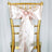 Gold chiavari chair with a pink satin bow and rhinestone embellishment.