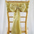 Gold chiavari chair with a yellow satin bow and ribbon decoration.
