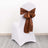 White chair cover with brown satin bow on the back