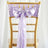 Lavender satin chair sash with bow on a gold chiavari chair