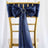 Navy satin chair sash with bow and ring detail on a gold chiavari chair