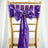 Purple satin chair sash with bow and ring on a gold chiavari chair.