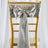 Silver satin chair sash with bow on a gold chiavari chair.