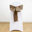 White chair with a brown satin bow tied on the back.