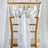 White satin chair sash with bow and rhinestone embellishment.