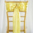 Yellow satin chair sash with bow and ring detail on a gold chiavari chair.