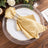 Elegant gold napkin with rhinestone ring on a decorative plate.