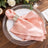 Elegant pink satin napkin with silver ring on a decorative plate.