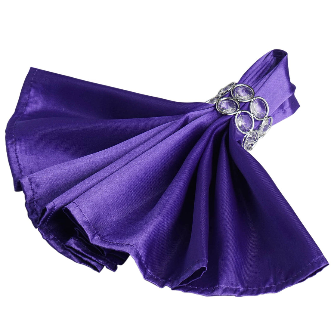 Purple satin napkin with jeweled ring on a white background