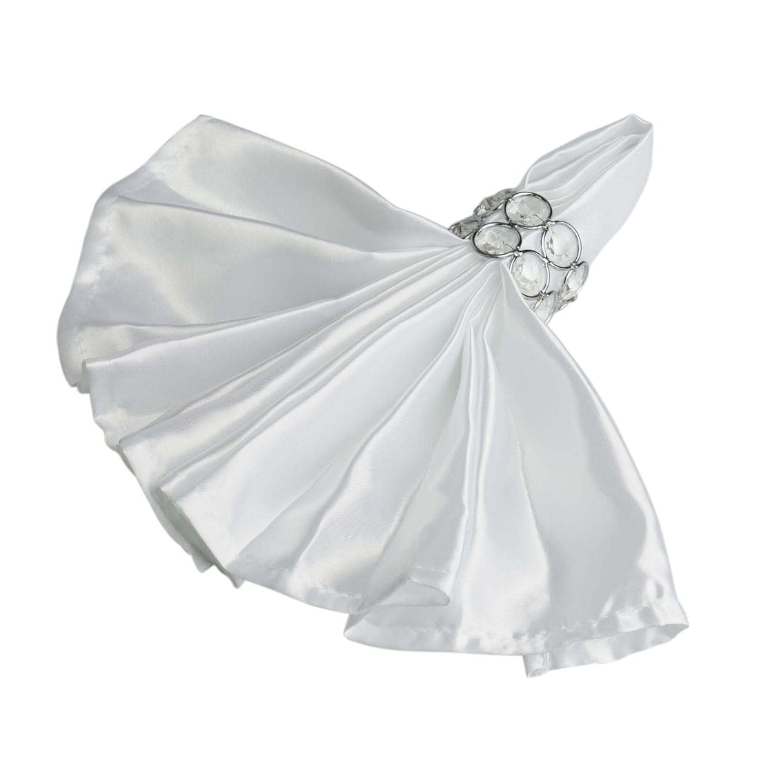 White satin napkin with jeweled ring holder, elegantly draped.