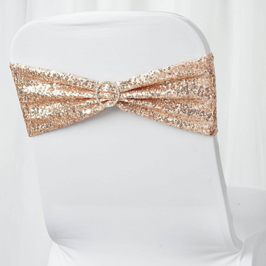 Rose gold sequin chair cover sash with decorative buckle.