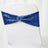 Blue sequin chair cover with a decorative ring accent on a white chair.