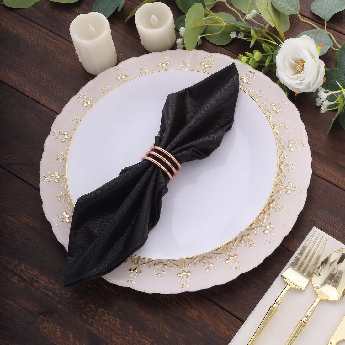 Black napkin elegantly styled on a decorative plate with gold accents.