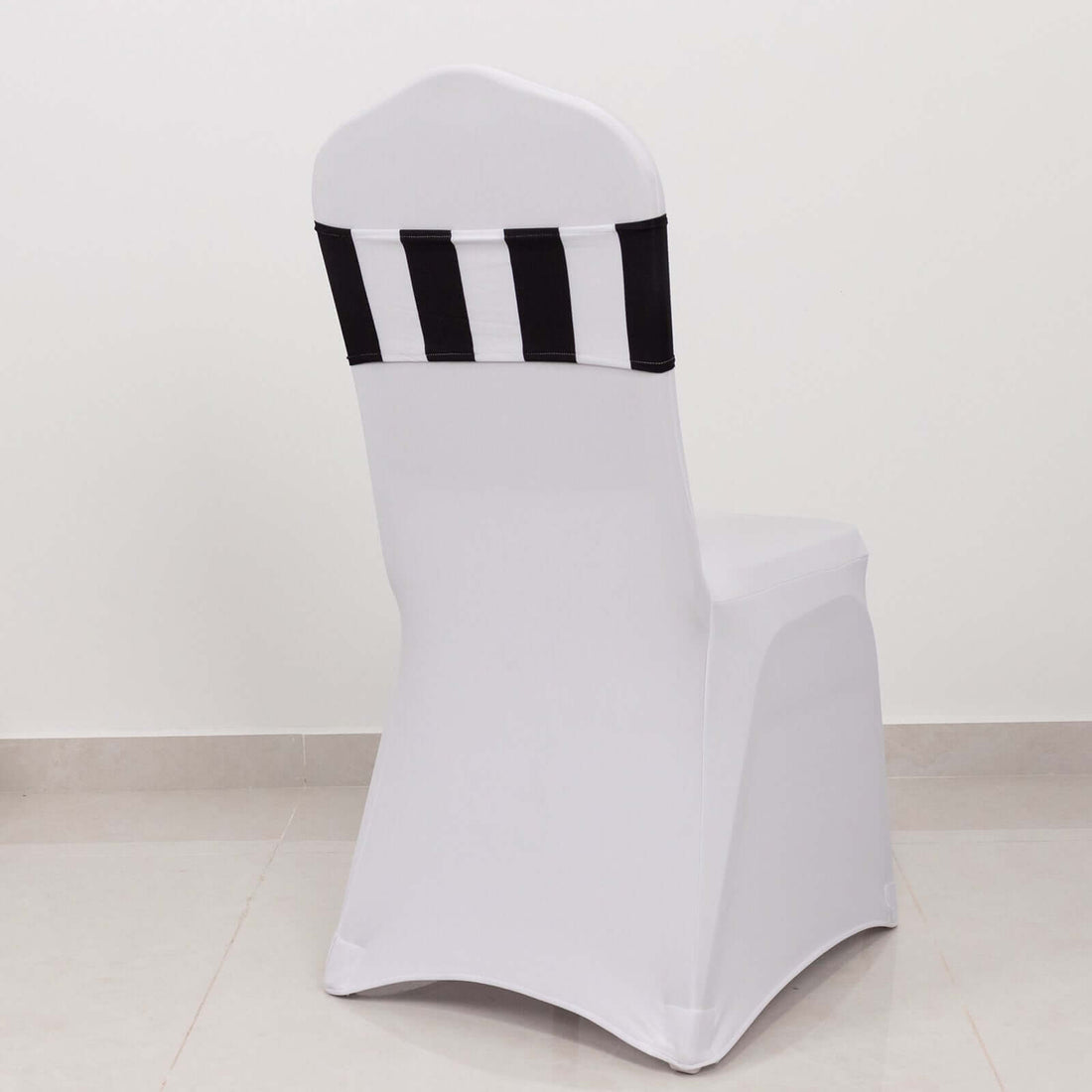 White chair cover with black stripes on a plain background
