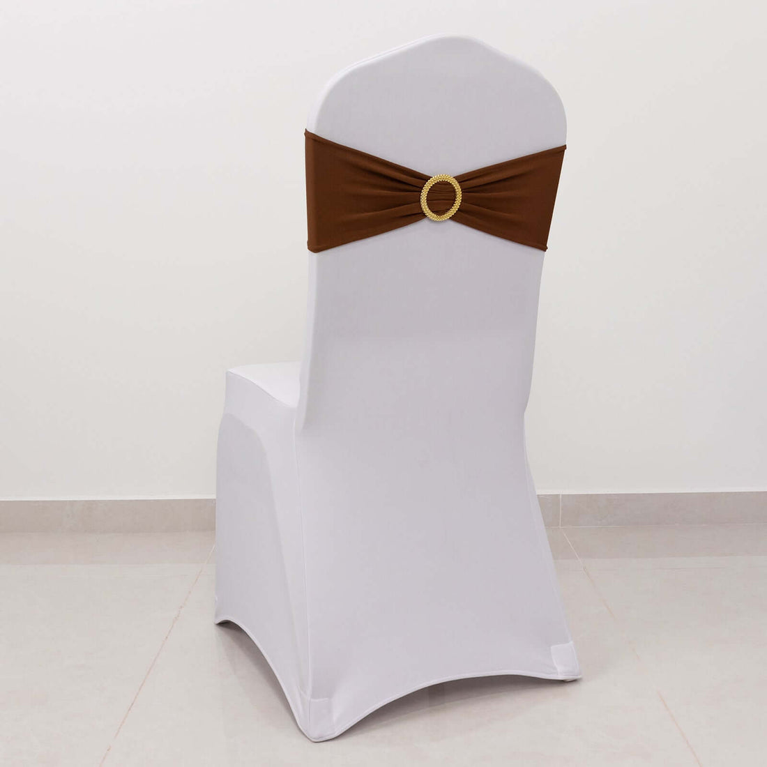 White chair cover with brown sash and decorative circle detail