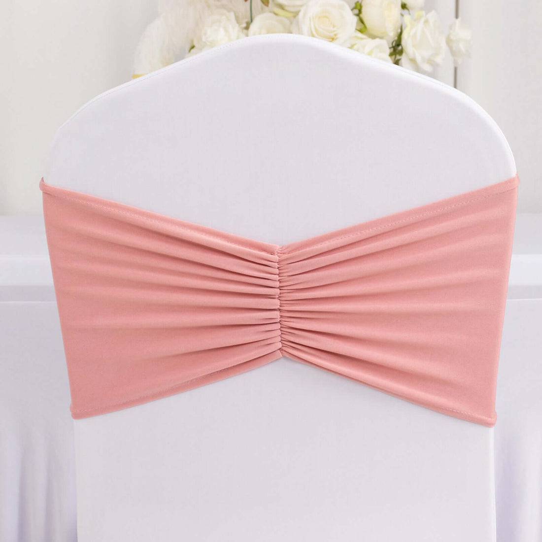 Pink chair cover with pleated design for elegant event decor.