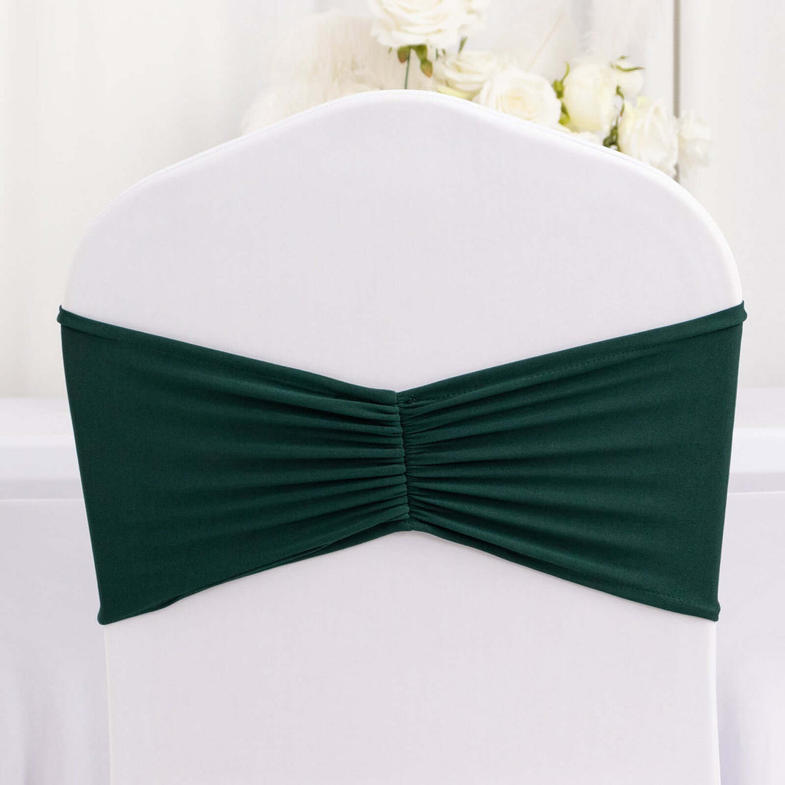 Green chair cover with gathered design for elegant event decor.