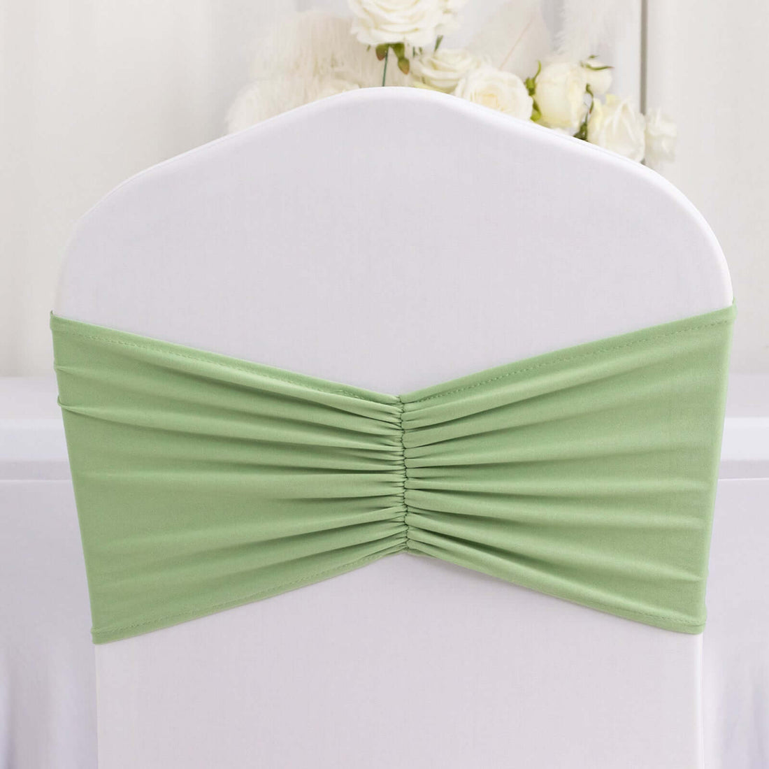 Green chair cover with gathered fabric detail.