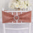 Rose gold chair sash with rhinestone buckle on white chair.