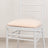 White chiavari chair with padded seat against a plain background.